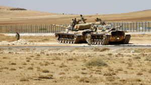 Turkish soldiers stand on top of tanks next to the Syrian-Trukish border fence near the town of Suruc in Sanliurfa province September 23, 2014. Some 138,000 Syrian Kurdish refugees have entered Turkey in an exodus that began last week, and two border crossing points remain open, the U.N. High Commissioner for Refugees said. REUTERS/Murad Sezer (TURKEY - Tags: POLITICS SOCIETY IMMIGRATION CONFLICT MILITARY)