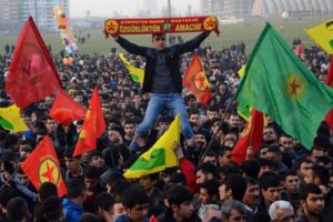 A man holds a scarf that reads" Kurdistan is my everything , freedom is my aim" during a rally on January 27, 2015 in Diyarbakir, southeastern Turkey, following news that Kurdish fighters drove the Islamic State group from the Syrian border town of Kobane, also known as Ain al-Arab, which became a major symbol of resistance against the jihadists. AFP PHOTO / ILYAS AKENGIN